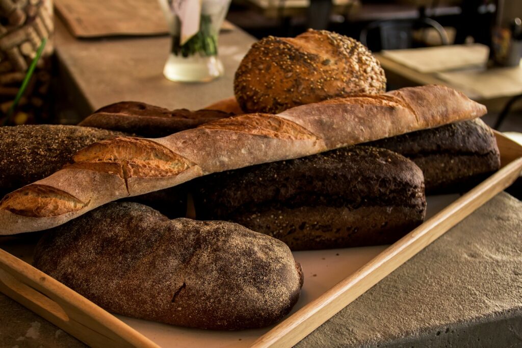 A loaf of bread baked on a white tray